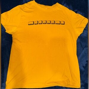 Primark mustard color t shirt with “TIRED” logo SIZE MEDIUM